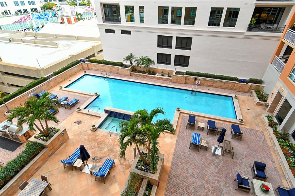 1350 Main Street, Unit 903 Sarasota, FL 34236 - Photo 10 of 71 a view of a swimming pool with outdoor seating and a potted plant