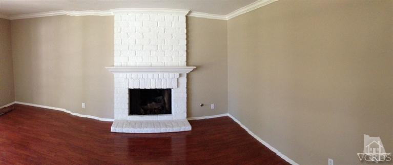 13755 Bear Valley Road Moorpark, CA 93021 - Photo 12 of 29 a view of an empty room with wooden floor and a fireplace