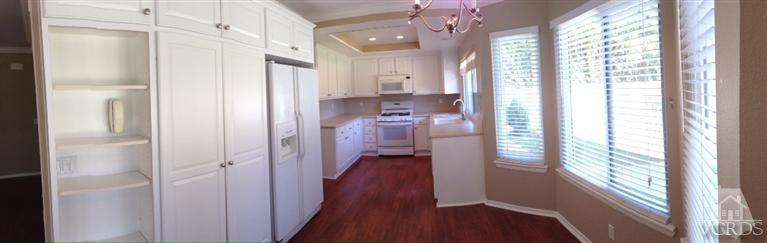 13755 Bear Valley Road Moorpark, CA 93021 - Photo 14 of 29 a view of a hallway with wooden floor and windows