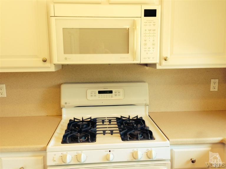 13755 Bear Valley Road Moorpark, CA 93021 - Photo 15 of 29 a kitchen with a stove and a white cabinet