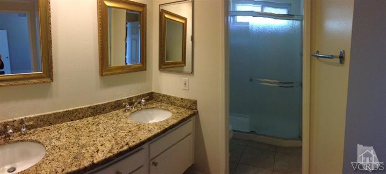 13755 Bear Valley Road Moorpark, CA 93021 - Photo 19 of 29 a bathroom with a granite countertop sink and a mirror