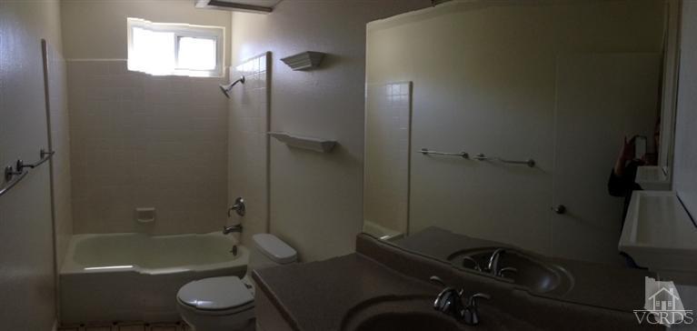 13755 Bear Valley Road Moorpark, CA 93021 - Photo 22 of 29 a bathroom with a sink a toilet and shower