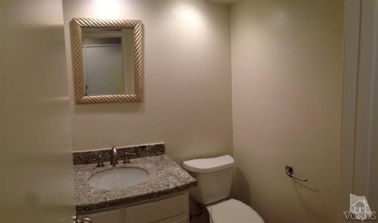 13755 Bear Valley Road Moorpark, CA 93021 - Photo 25 of 29 a bathroom with a granite countertop sink and a toilet