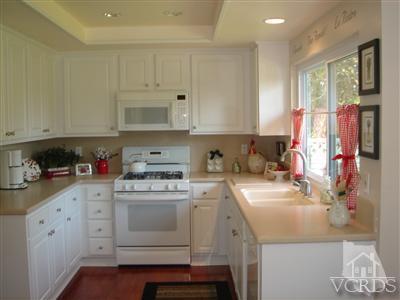 13755 Bear Valley Road Moorpark, CA 93021 - Photo 6 of 29 a kitchen with cabinets appliances and a counter space