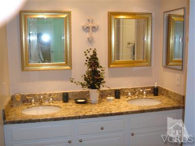 13755 Bear Valley Road Moorpark, CA 93021 - Photo 10 of 29 a bathroom with a granite countertop sink and a mirror