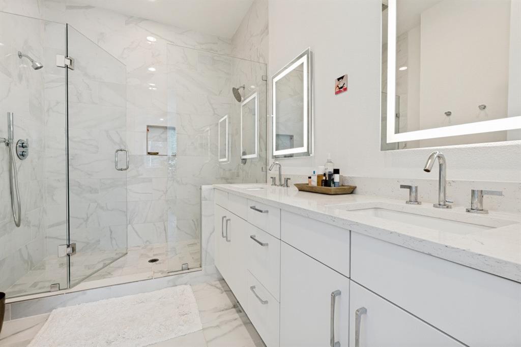 1952 Kearney Court Dallas, TX 75204 - Photo 16 of 24 a bathroom with a shower sink and mirror