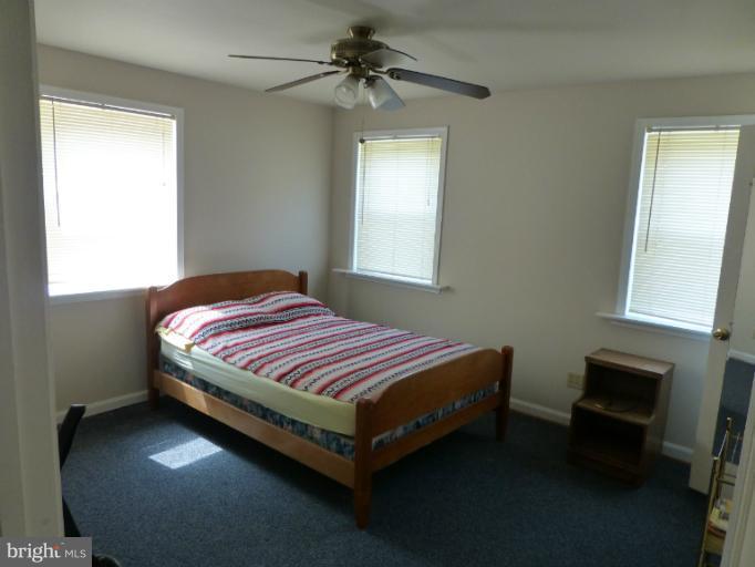 11925 Andrew Street Silver Spring, MD 20902 - Photo 1 of 23 a bedroom with a bed and a table in it