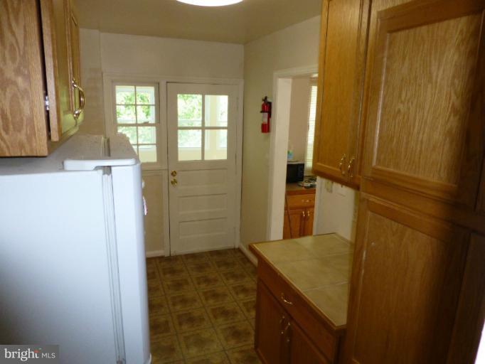 11925 Andrew Street Silver Spring, MD 20902 - Photo 2 of 23 a bathroom with a granite countertop sink and a mirror