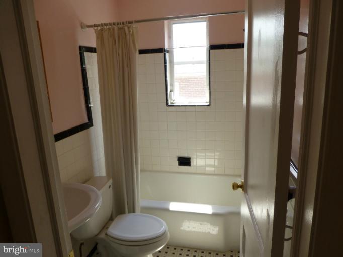 11925 Andrew Street Silver Spring, MD 20902 - Photo 11 of 23 a bathroom with a toilet a sink and a shower