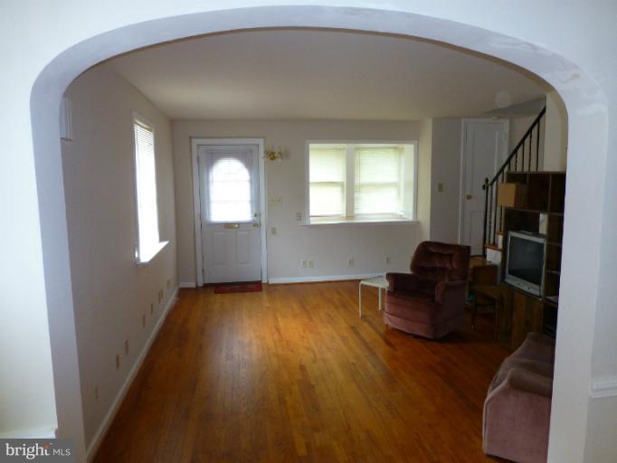 11925 Andrew Street Silver Spring, MD 20902 - Photo 13 of 23 a living room with furniture and a flat screen tv
