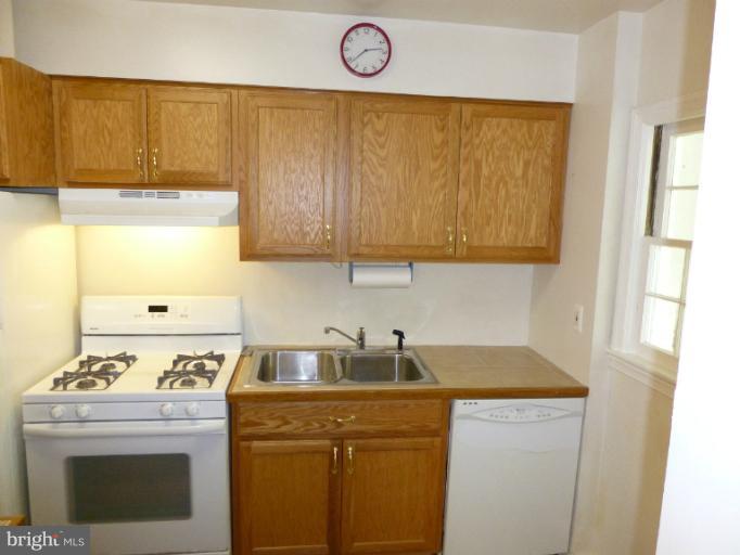 11925 Andrew Street Silver Spring, MD 20902 - Photo 17 of 23 a kitchen with a sink a stove and a window