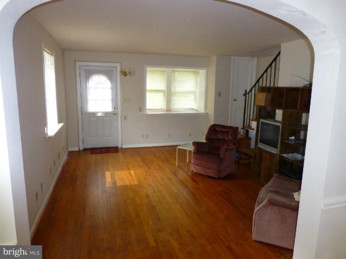 11925 Andrew Street Silver Spring, MD 20902 - Photo 20 of 23 a living room with furniture and a hard wood floor