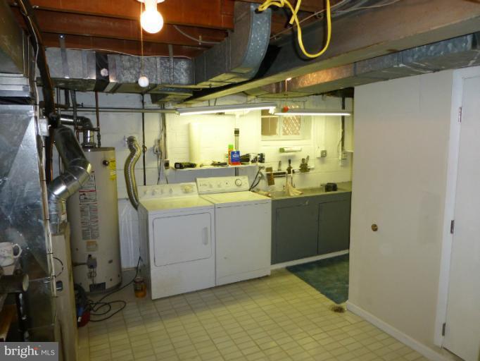 11925 Andrew Street Silver Spring, MD 20902 - Photo 3 of 23 a utility room with cabinets