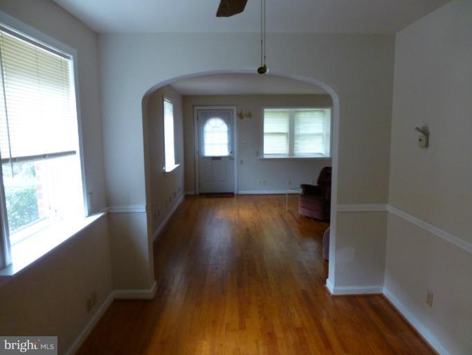 11925 Andrew Street Silver Spring, MD 20902 - Photo 4 of 23 wooden floor in an empty room with a window