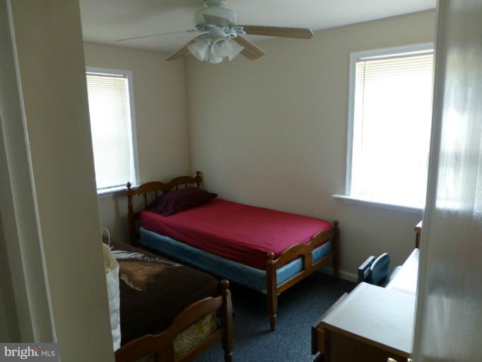 11925 Andrew Street Silver Spring, MD 20902 - Photo 7 of 23 a bedroom with a bed and a window
