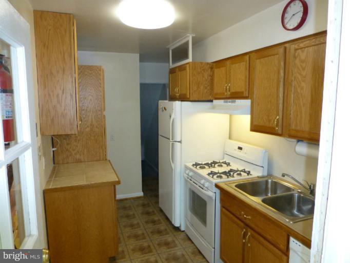 11925 Andrew Street Silver Spring, MD 20902 - Photo 8 of 23 a kitchen that has a sink and a stove in it