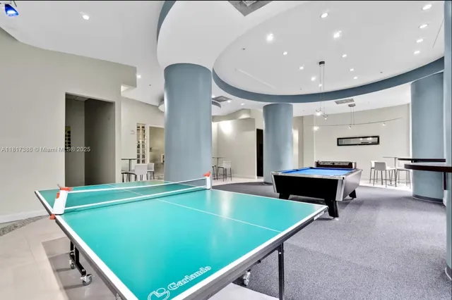 a room with pool table and furniture