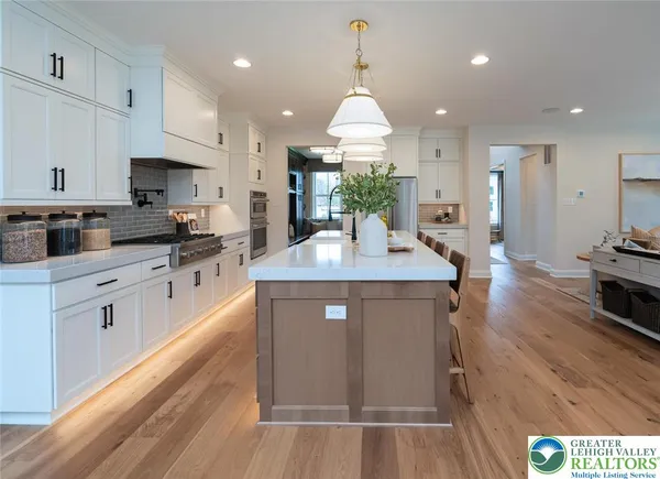 a large kitchen with lots of counter space and chandelier