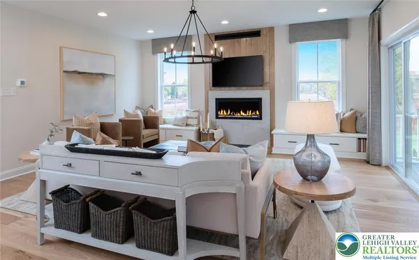 a kitchen with a stove a sink and a chandelier