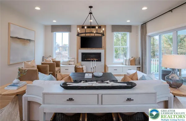 a living room with furniture a window and a fireplace