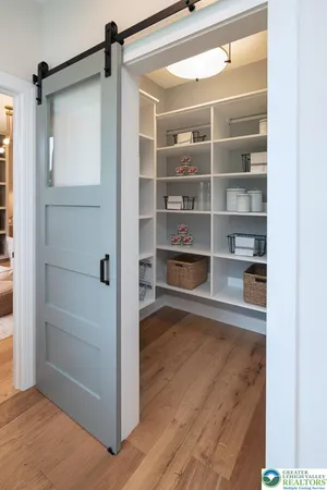a living room with furniture and a book shelf