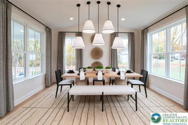 a dining room with wooden floor a glass table and chairs