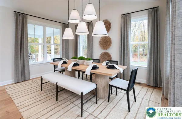 a kitchen with stainless steel appliances kitchen island granite countertop a stove a sink a refrigerator and a dining table with wooden floor