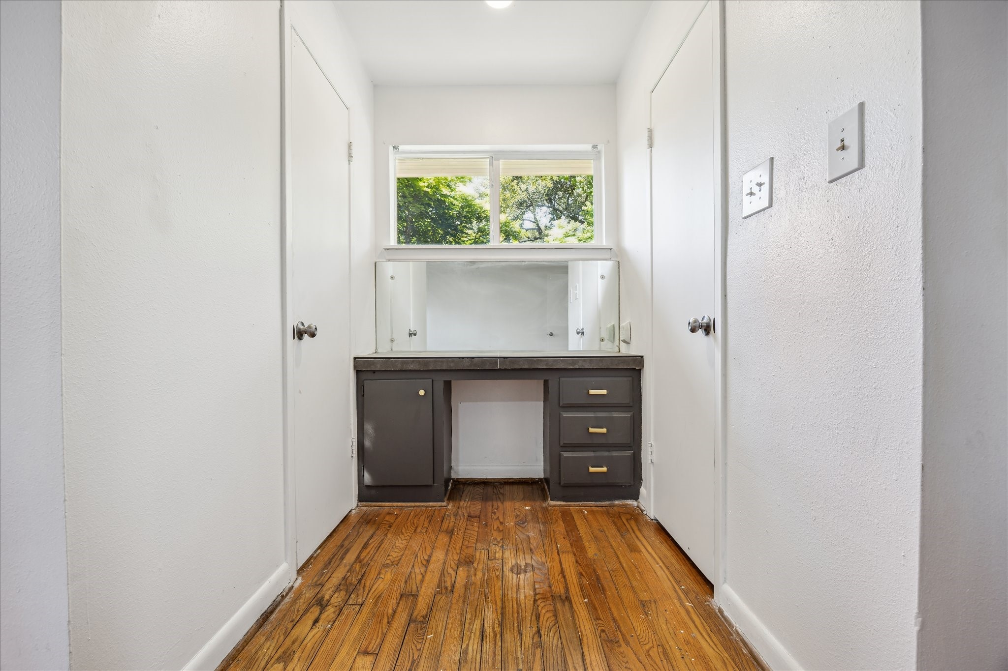 5419 Beechnut Street Houston, TX 77096 - Photo 18 of 28 Primary suite includes a built-in vanity or desk area with storage and natural light.