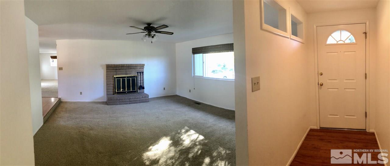 13870 Chamy Drive Reno, NV 89521 - Photo 4 of 21 a view of a hallway with a chandelier
