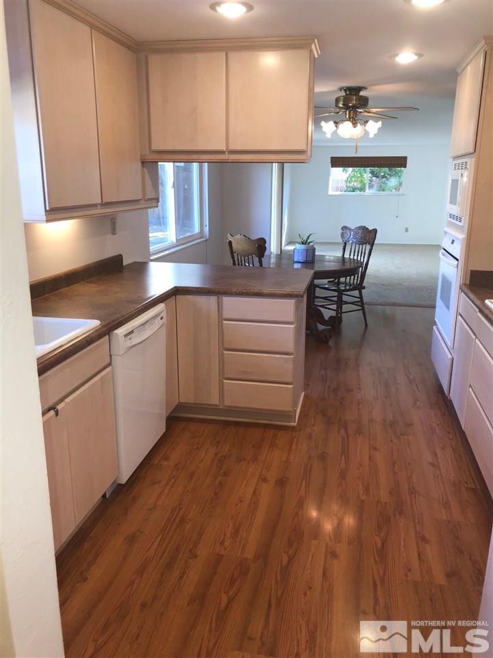 13870 Chamy Drive Reno, NV 89521 - Photo 6 of 21 a kitchen with cabinets and wooden floor