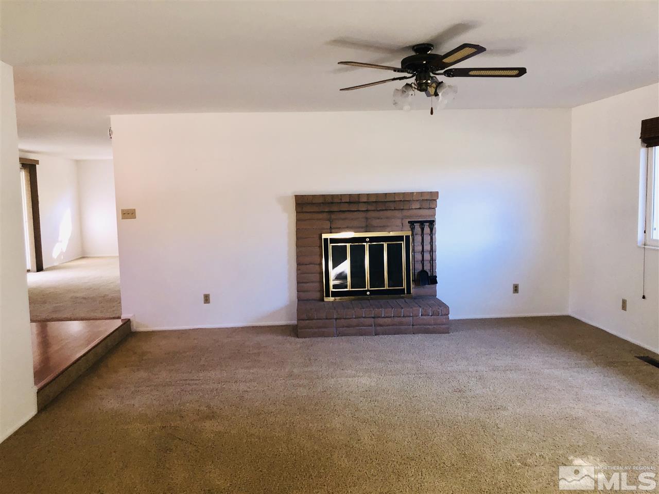 13870 Chamy Drive Reno, NV 89521 - Photo 7 of 21 a view of an empty room with a fireplace