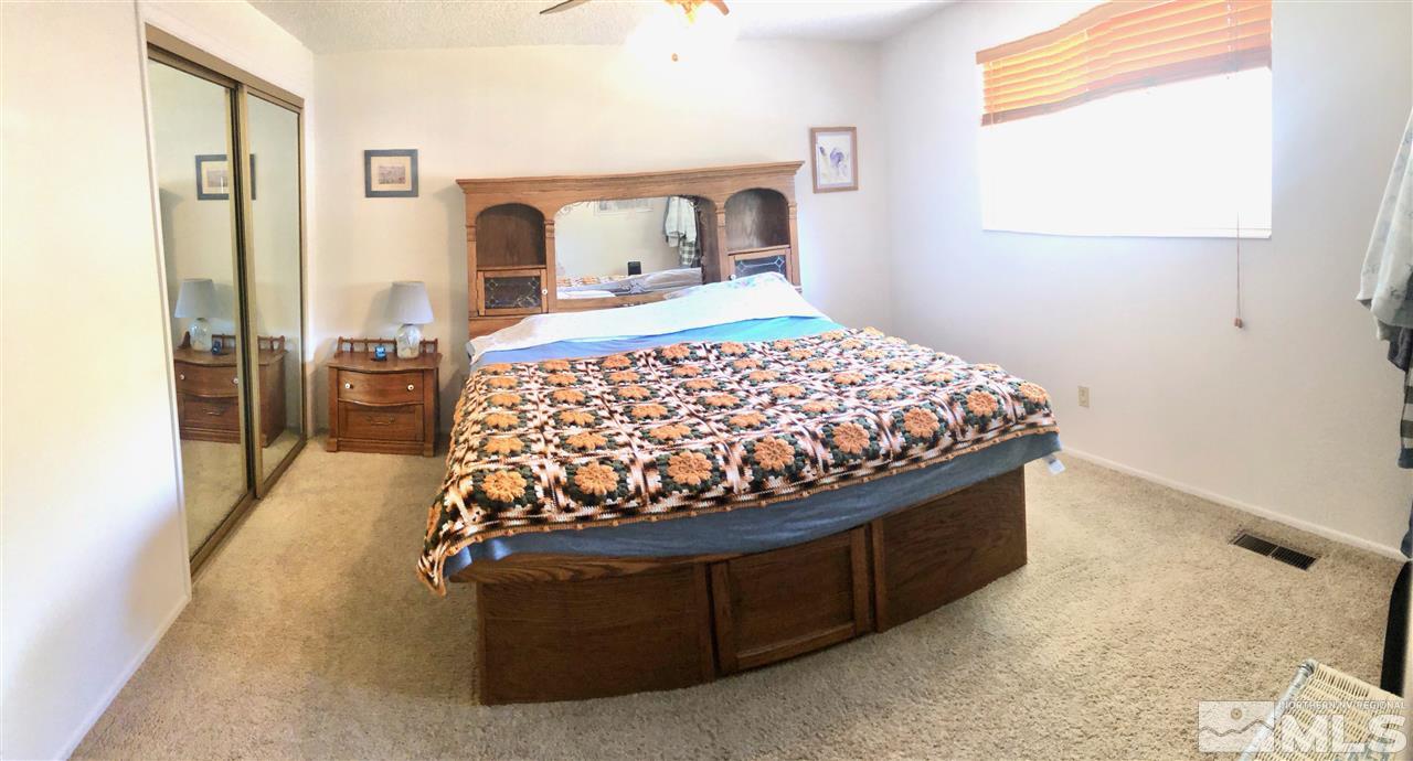 13870 Chamy Drive Reno, NV 89521 - Photo 9 of 21 a bed sitting in a bedroom next to a window