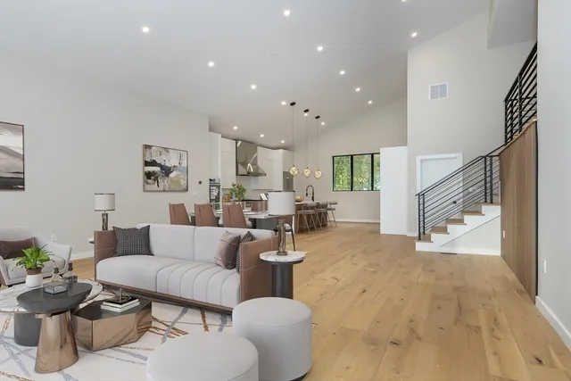 a living room with furniture and flowers