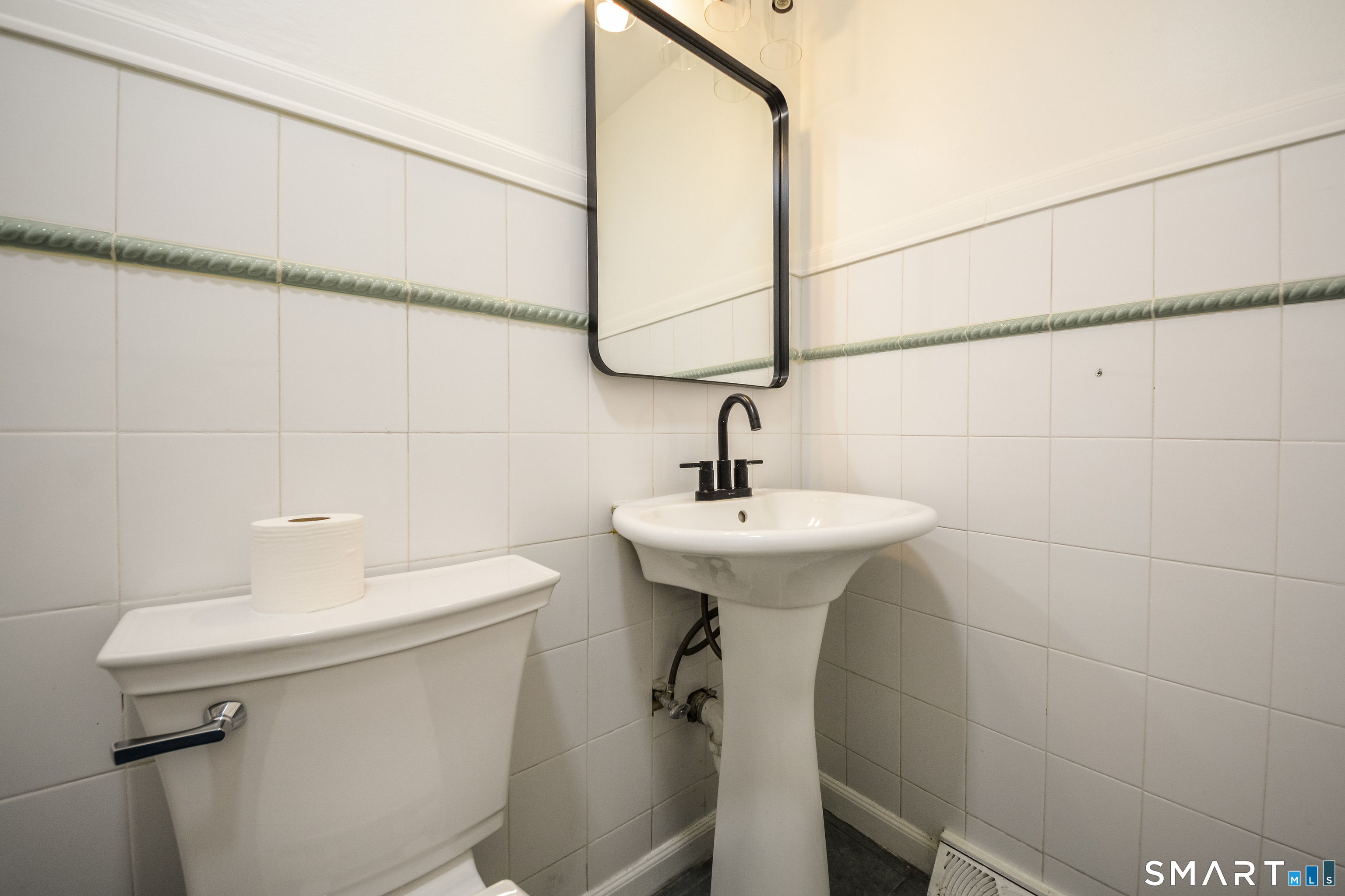 32 Towne House Road, Unit 32 Hamden, CT 06514 - Photo 11 of 35 a bathroom with a sink a toilet and a mirror