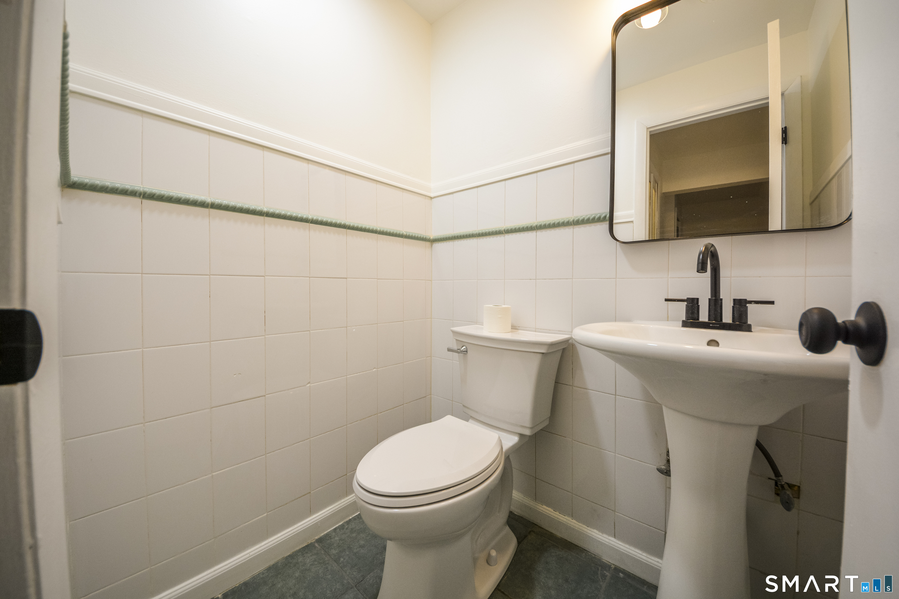 32 Towne House Road, Unit 32 Hamden, CT 06514 - Photo 12 of 35 a bathroom with a toilet sink and mirror