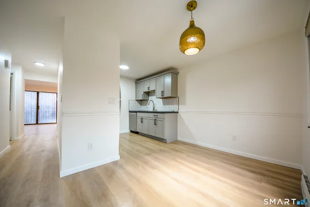 a view of a kitchen cabinets and wooden floor