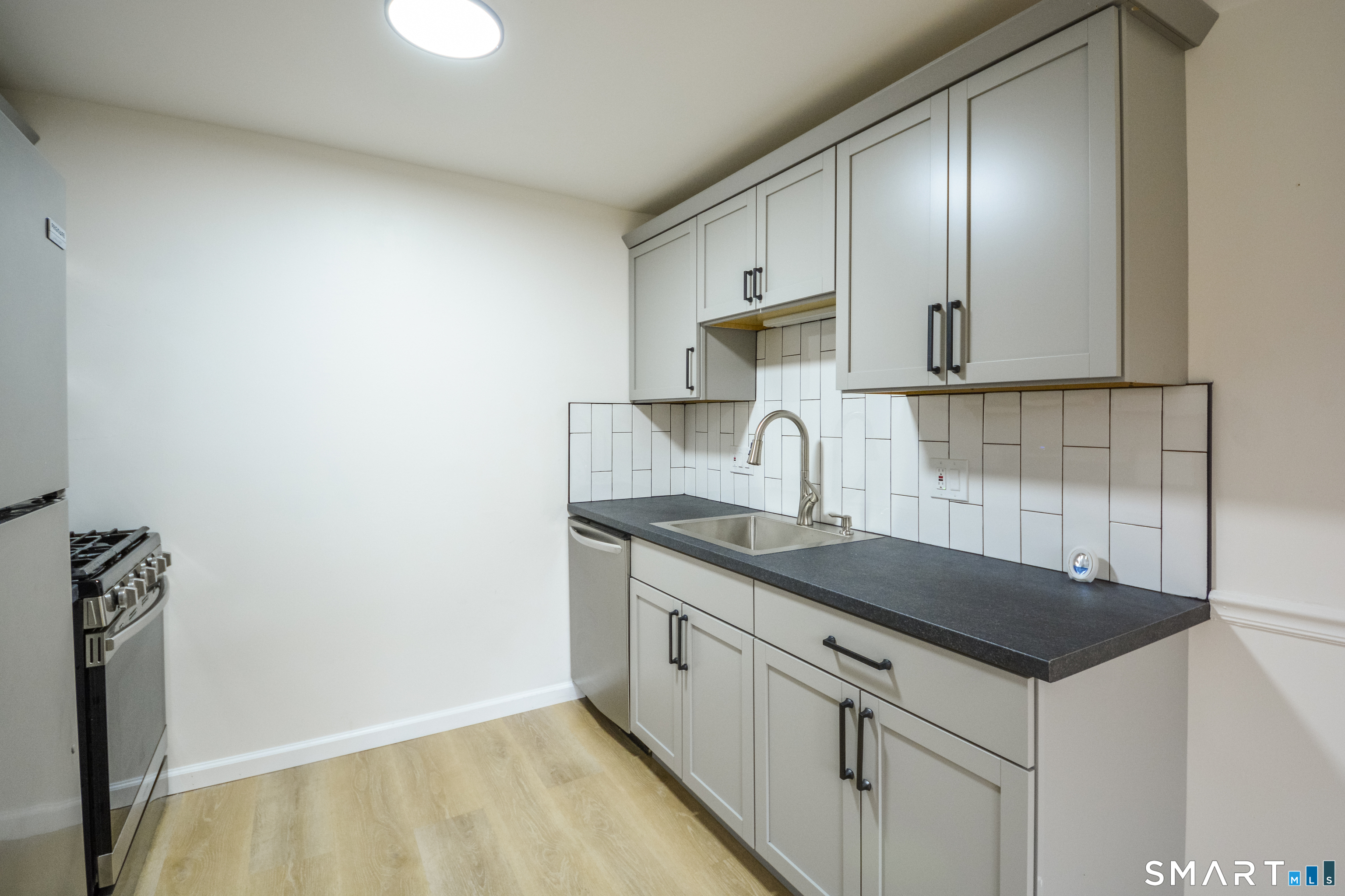 32 Towne House Road, Unit 32 Hamden, CT 06514 - Photo 14 of 35 a kitchen with granite countertop a sink and cabinets