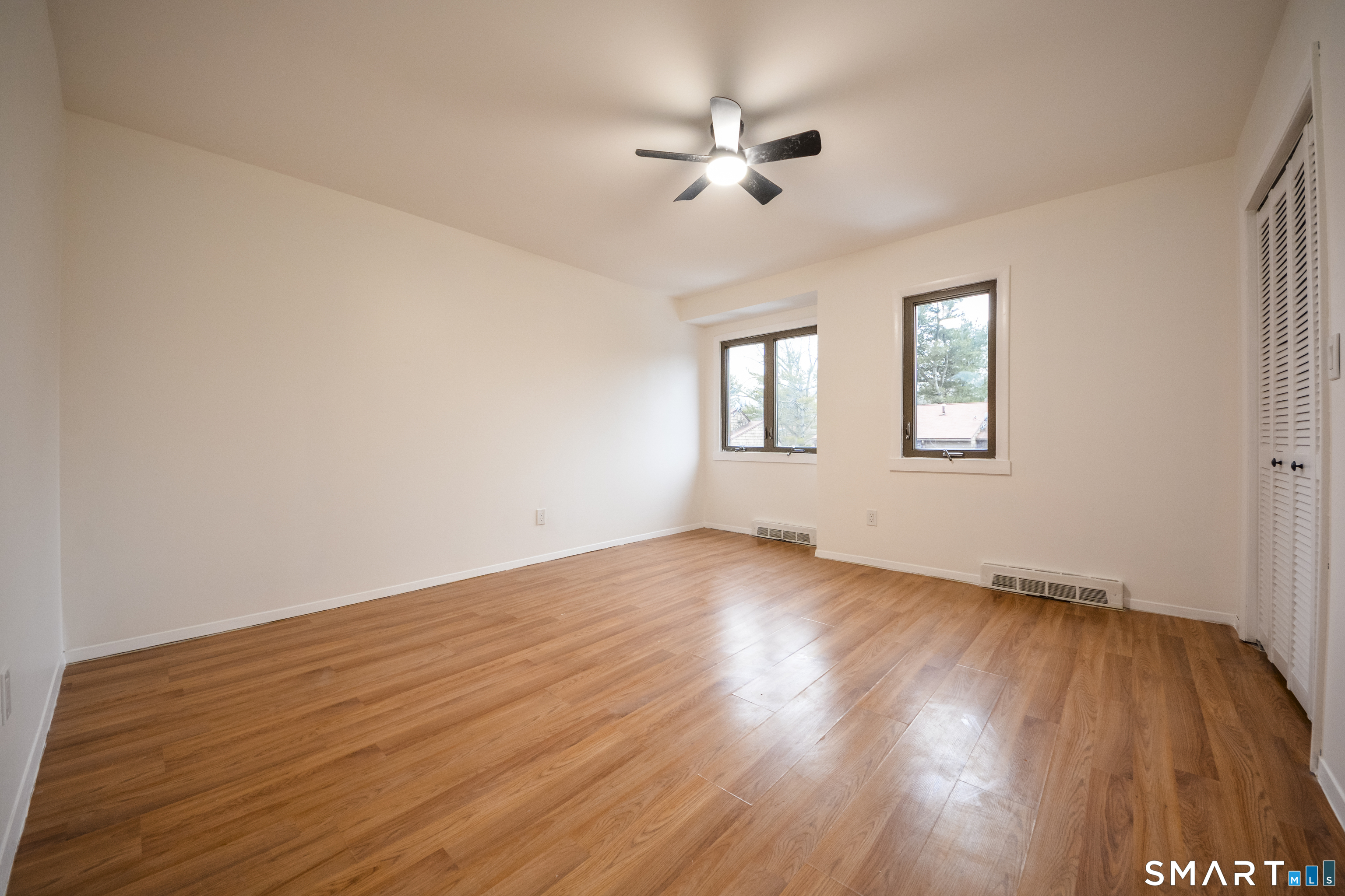 32 Towne House Road, Unit 32 Hamden, CT 06514 - Photo 19 of 35 a view of an empty room with wooden floor and a window