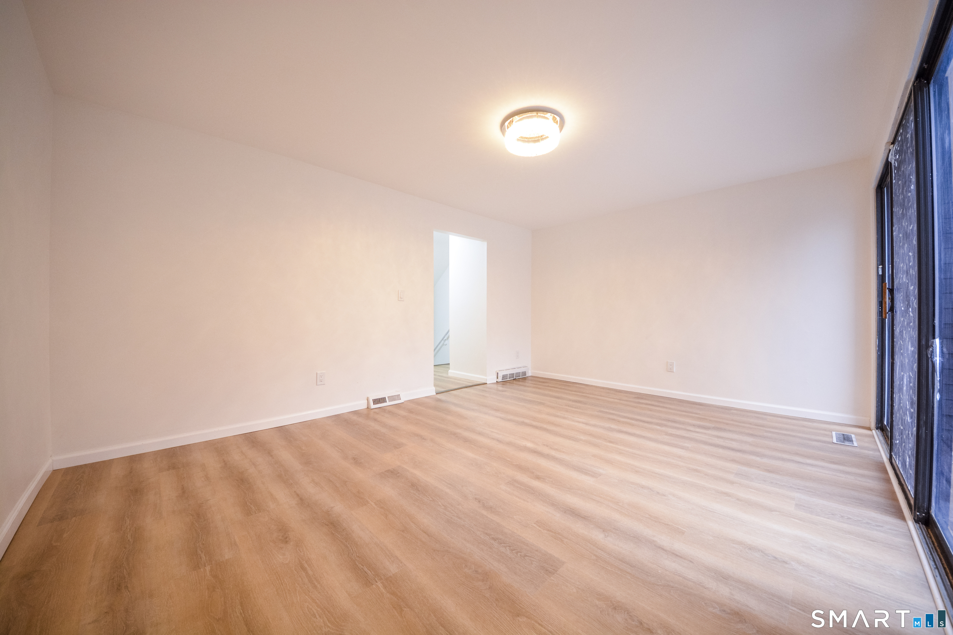 32 Towne House Road, Unit 32 Hamden, CT 06514 - Photo 21 of 35 a view of empty room with wooden floor and fan