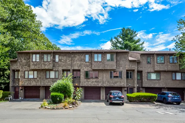 a front view of a residential apartment building with a yard