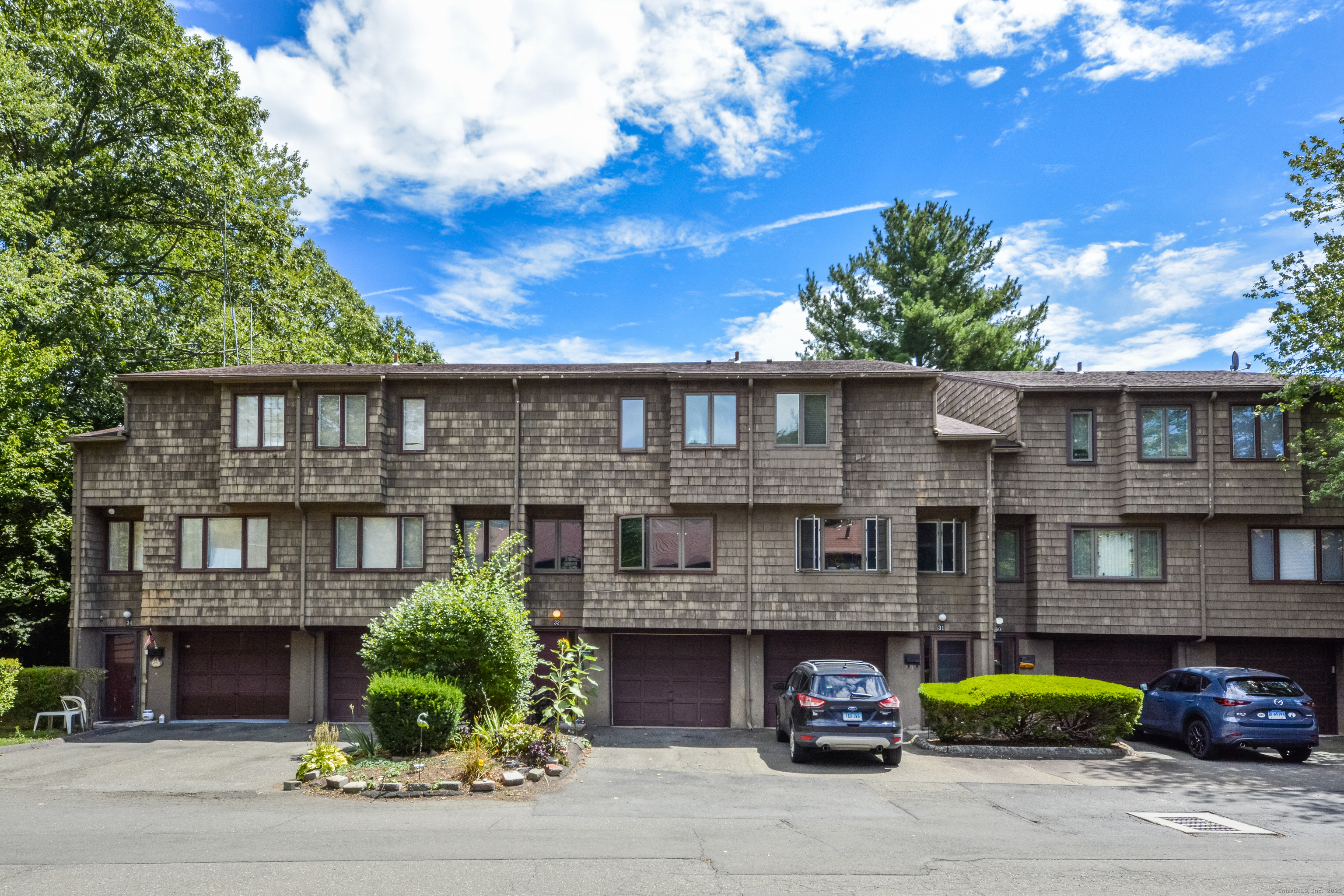 32 Towne House Road, Unit 32 Hamden, CT 06514 - Photo 26 of 35 a front view of a residential apartment building with a yard