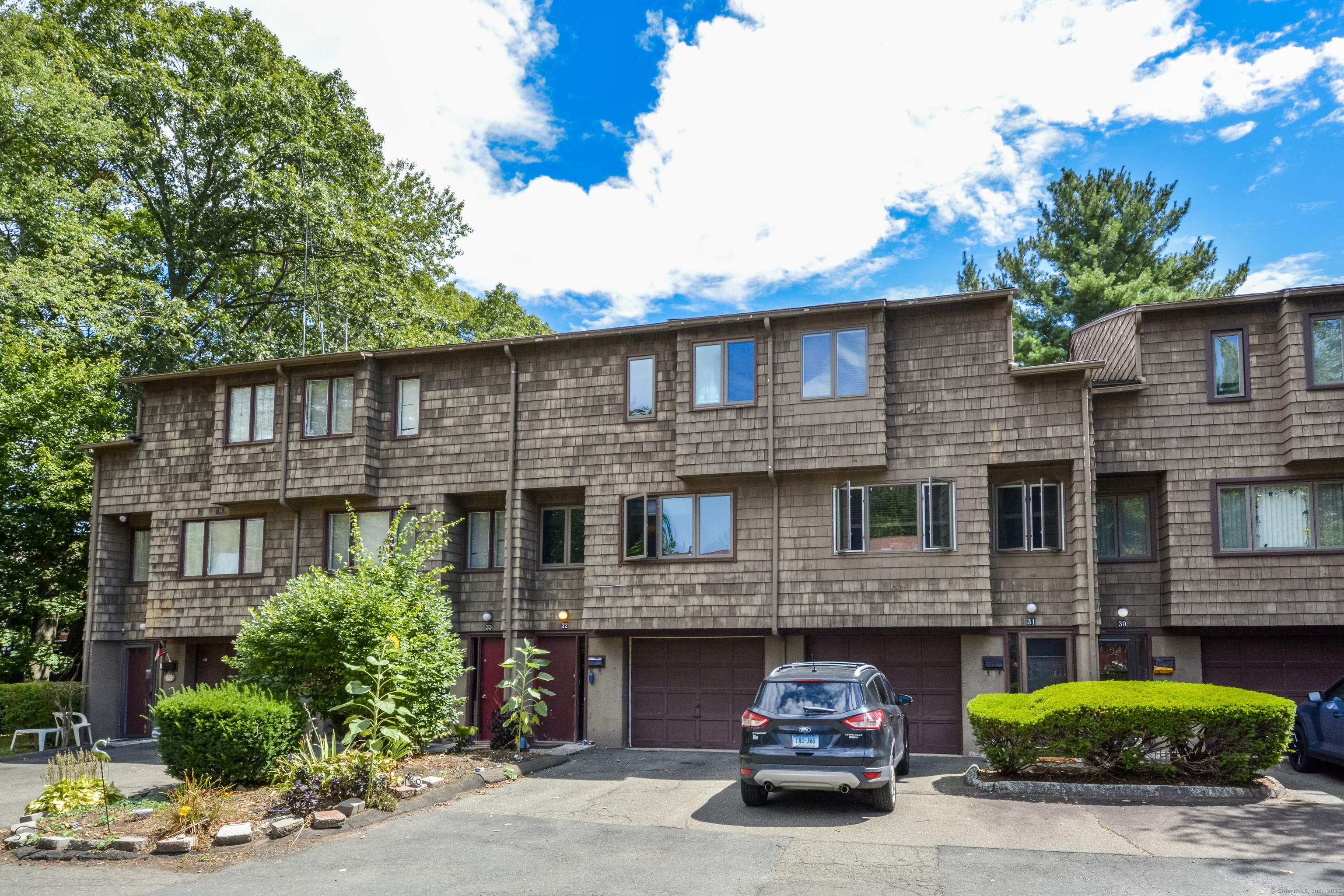 32 Towne House Road, Unit 32 Hamden, CT 06514 - Photo 27 of 35 a front view of a house with a yard