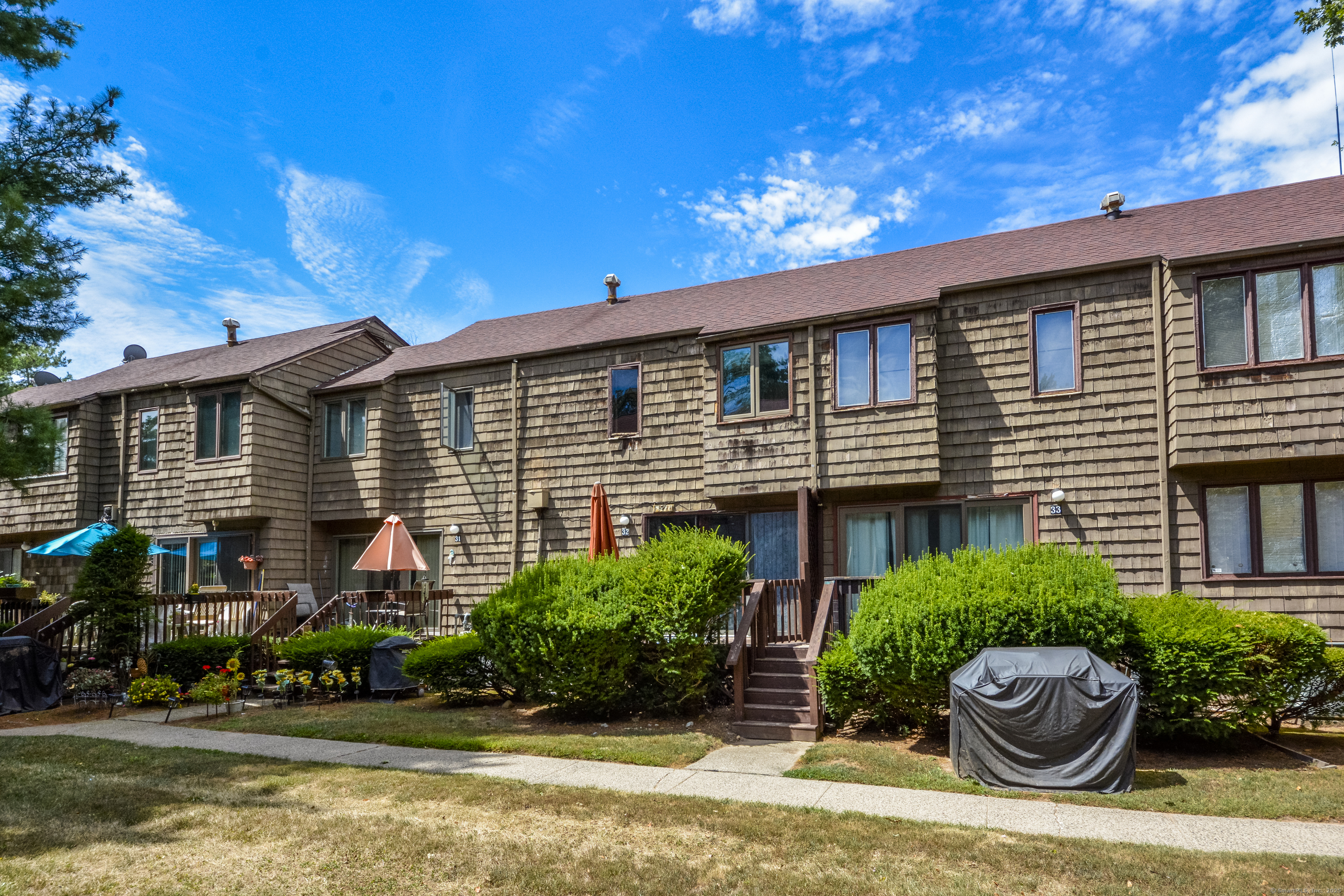 32 Towne House Road, Unit 32 Hamden, CT 06514 - Photo 28 of 35 a front view of a house with a yard and potted plants