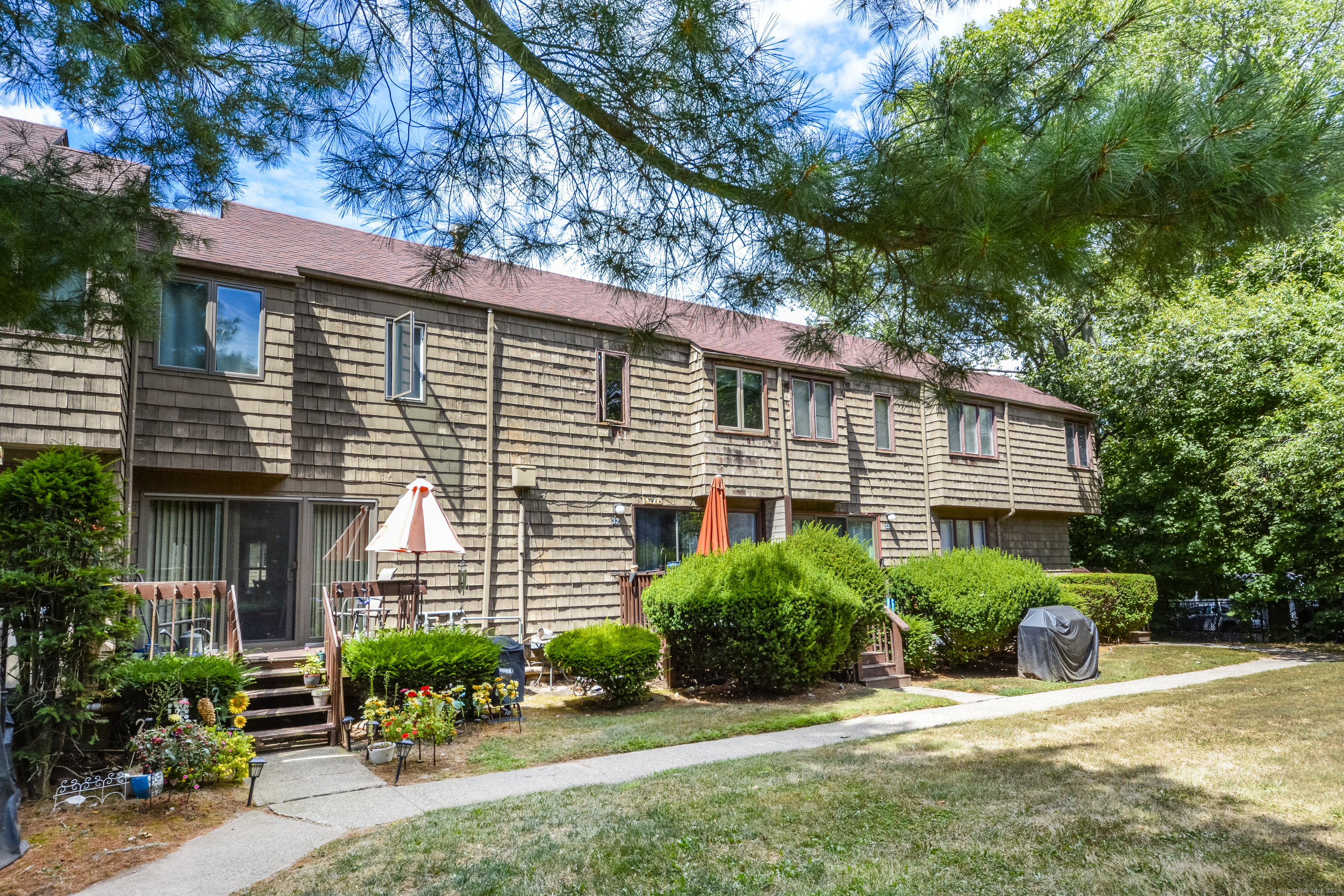 32 Towne House Road, Unit 32 Hamden, CT 06514 - Photo 29 of 35 a view of a house with a yard and potted plants