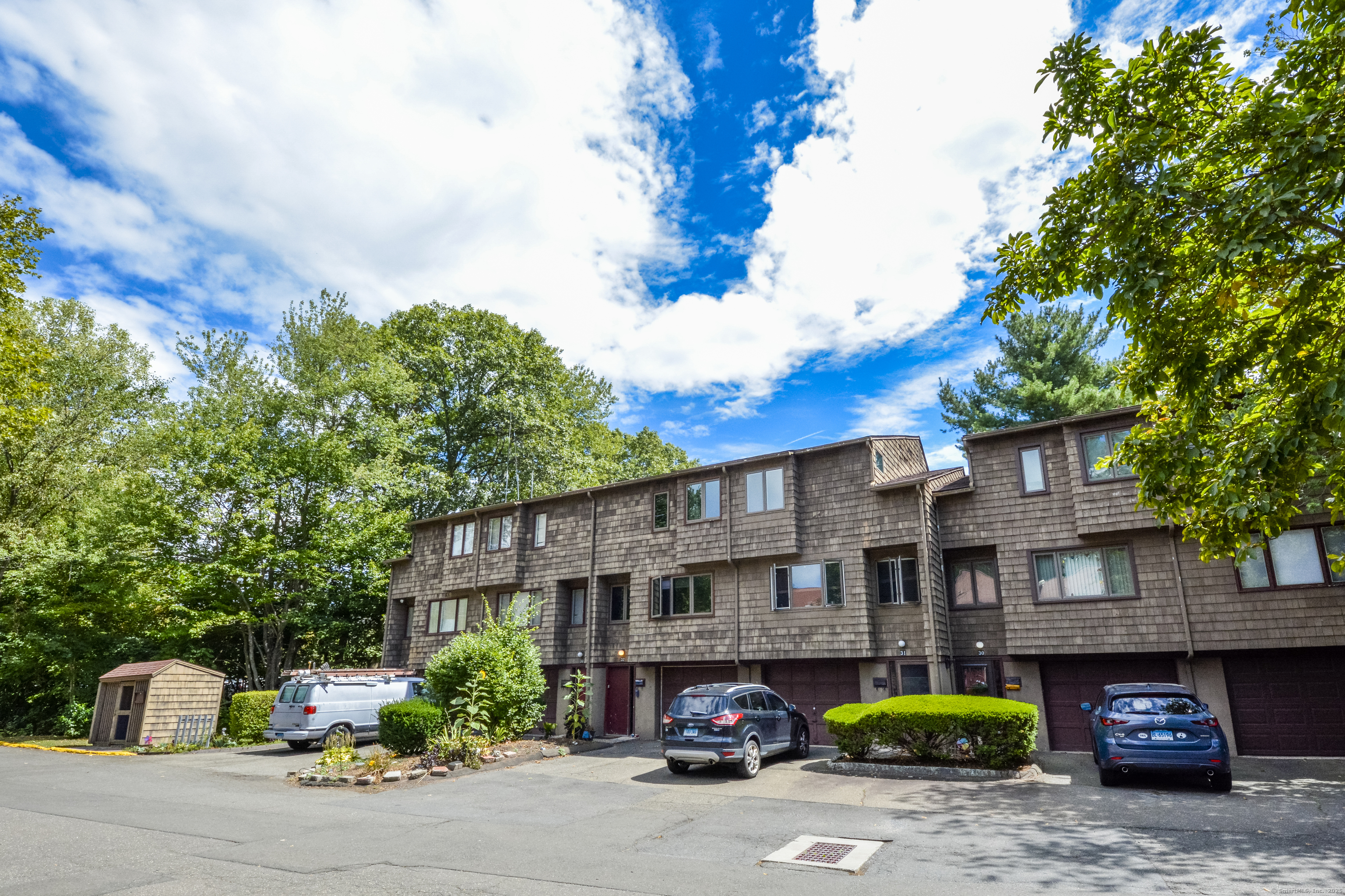 32 Towne House Road, Unit 32 Hamden, CT 06514 - Photo 32 of 35 a red and white building with trees in front of it