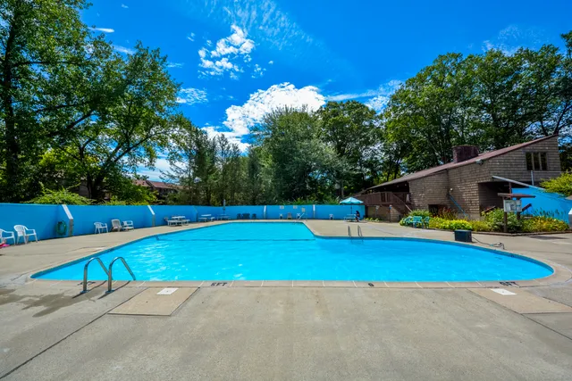 a view of pool with a yard