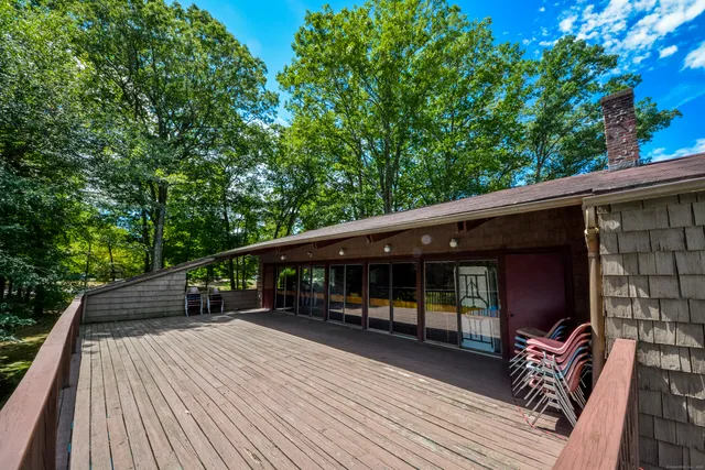 a balcony with furniture and wooden floor