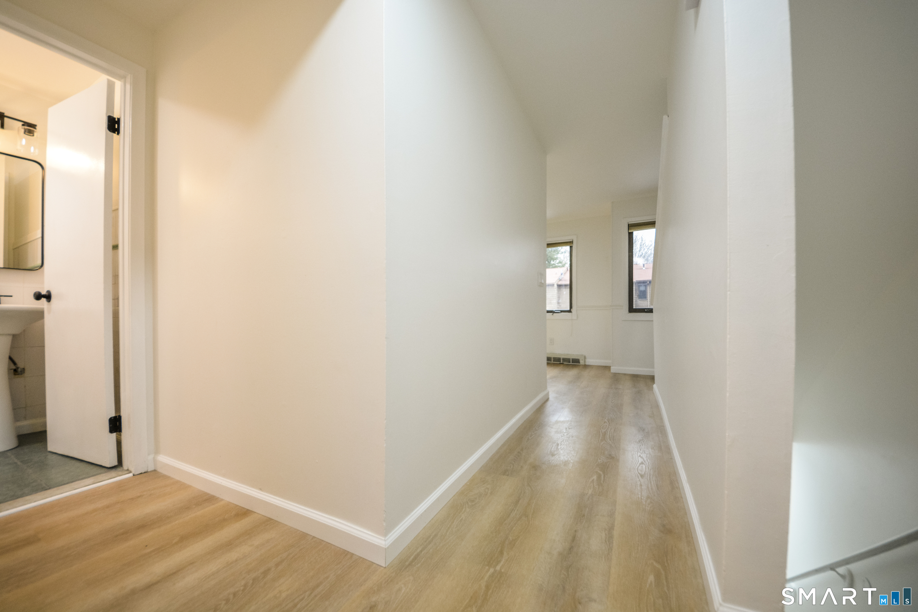 32 Towne House Road, Unit 32 Hamden, CT 06514 - Photo 9 of 35 a view of a hallway with wooden floor