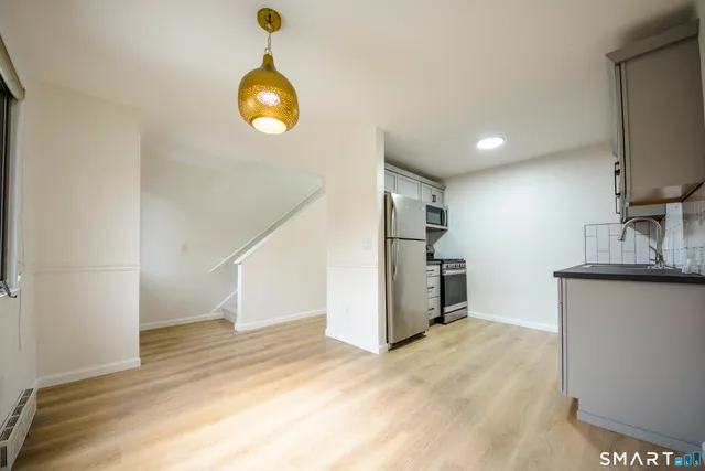 a view of a kitchen with a sink and a window
