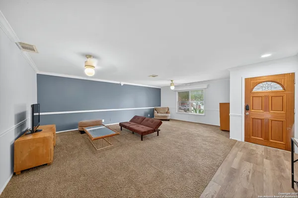 a living room with furniture and wooden floor